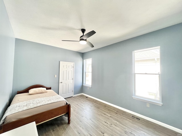 1505 High St, Logansport, IN 46947 - bedroom featuring wood finished floors, visible vents, baseboards, and ceiling fan
