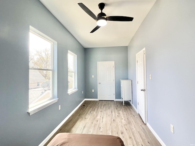 1505 High St, Logansport, IN 46947 - unfurnished bedroom featuring ceiling fan, baseboards, and light wood-style flooring