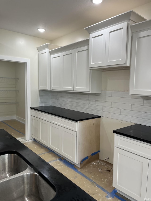 6021 Glencrest Ct, Newburgh, IN 47630 - kitchen featuring decorative backsplash, a sink, dark countertops, white cabinetry, and recessed lighting