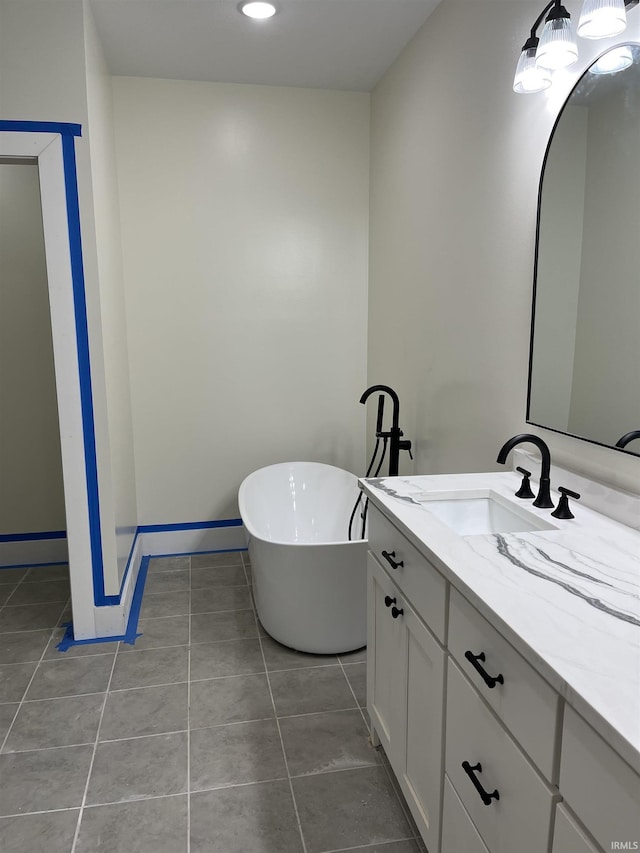 6021 Glencrest Ct, Newburgh, IN 47630 - bathroom featuring tile patterned floors, a freestanding bath, vanity, baseboards, and recessed lighting