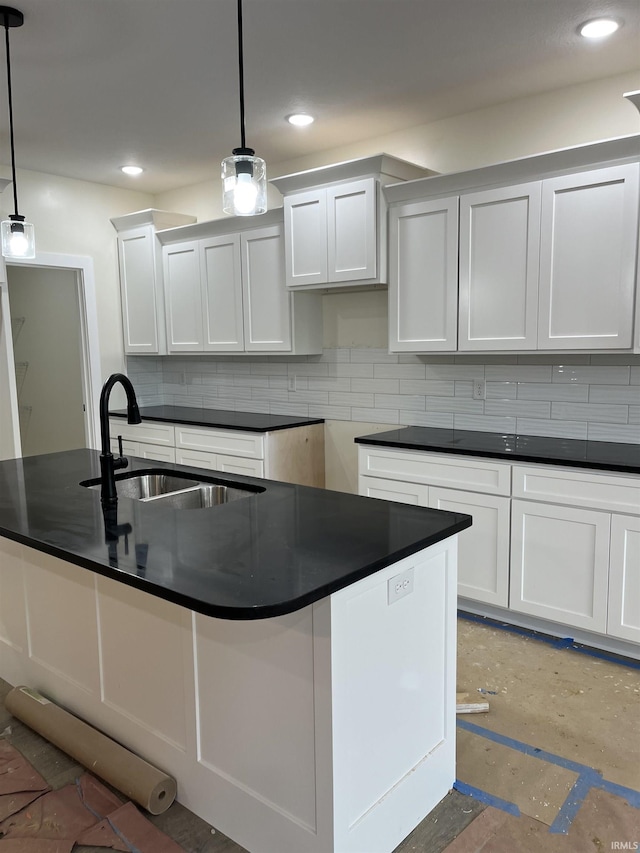 6021 Glencrest Ct, Newburgh, IN 47630 - kitchen featuring dark countertops, a sink, backsplash, pendant lighting, and white cabinets