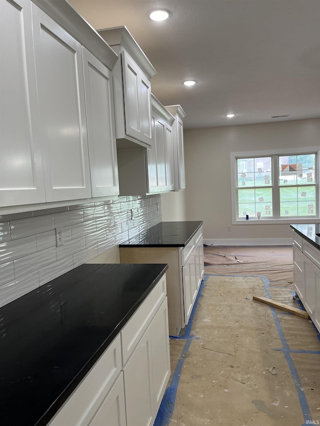 6021 Glencrest Ct, Newburgh, IN 47630 - kitchen with tasteful backsplash, dark countertops, recessed lighting, white cabinetry, and baseboards