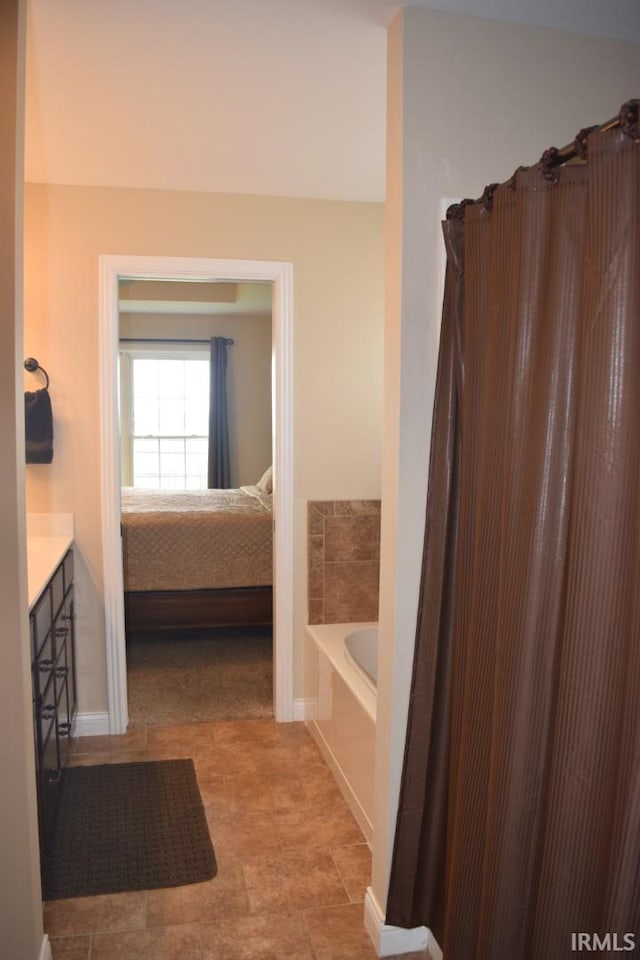 3201 Helmsford Ct, Evansville, IN 47715 - ensuite bathroom with ensuite bath, baseboards, vanity, and a bathing tub