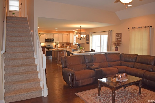 3201 Helmsford Ct, Evansville, IN 47715 - living room with dark wood finished floors, vaulted ceiling, recessed lighting, ceiling fan with notable chandelier, and stairs