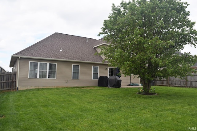 3201 Helmsford Ct, Evansville, IN 47715 - back of house with a lawn, a fenced backyard, and roof with shingles
