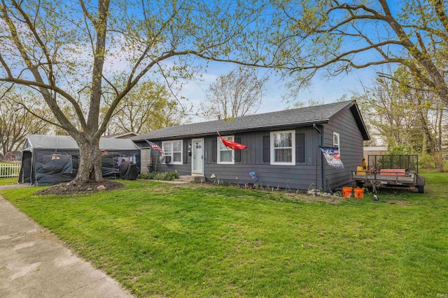 ranch-style home with a front lawn and a wooden deck