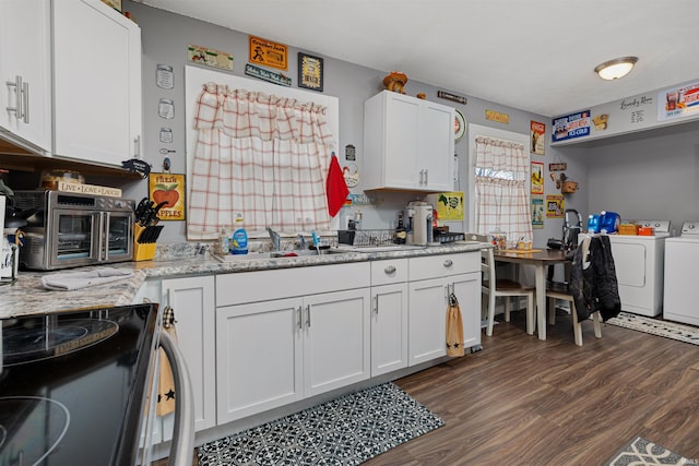 kitchen featuring dark wood-style floors, independent washer and dryer, white cabinetry, and electric stove