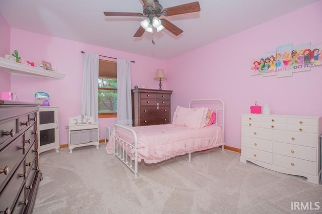bedroom with baseboards, a ceiling fan, and carpet