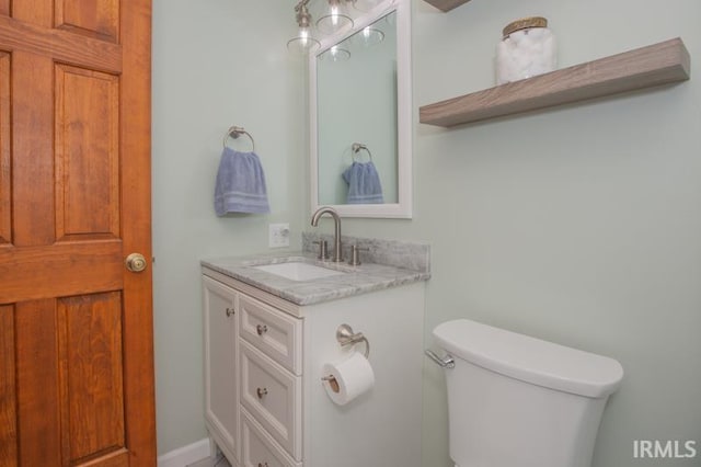 bathroom with toilet and vanity