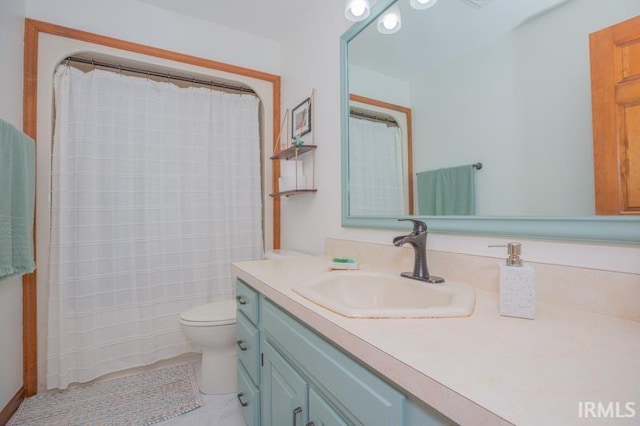 bathroom with toilet, vanity, and a shower with curtain