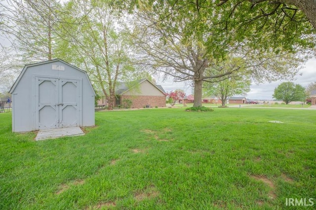 view of yard with an outbuilding and a shed