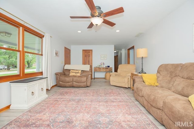living room featuring recessed lighting, light wood-style flooring, and ceiling fan