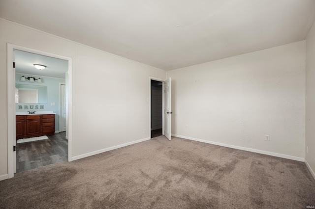 357 Mount Auburn St, Dunkirk, IN 47336 - unfurnished bedroom featuring dark carpet, baseboards, ensuite bathroom, and a sink