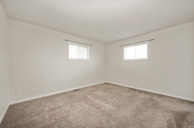 357 Mount Auburn St, Dunkirk, IN 47336 - spare room featuring visible vents, carpet, baseboards, and a wealth of natural light