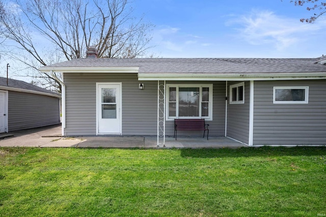 357 Mount Auburn St, Dunkirk, IN 47336 - rear view of property featuring a lawn, roof with shingles, a patio area, and a chimney