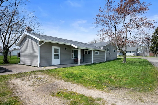 357 Mount Auburn St, Dunkirk, IN 47336 - ranch-style home with a front lawn, a patio area, and a chimney