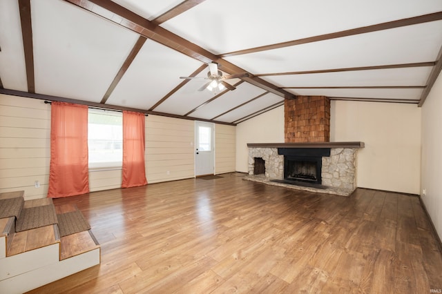 357 Mount Auburn St, Dunkirk, IN 47336 - unfurnished living room with wood finished floors, vaulted ceiling with beams, a stone fireplace, and ceiling fan