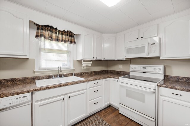 357 Mount Auburn St, Dunkirk, IN 47336 - kitchen with dark countertops, white appliances, a sink, and white cabinetry