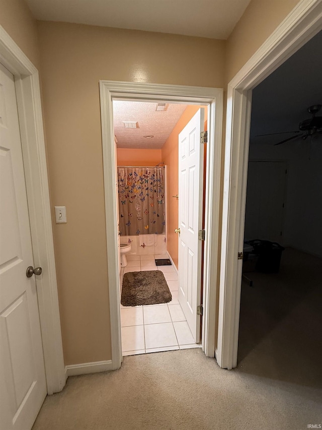 hall with light carpet and baseboards