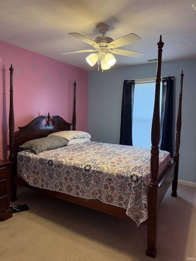 bedroom with light carpet, visible vents, and ceiling fan