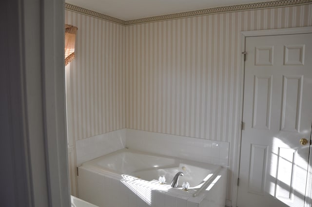 bathroom with a bath and wallpapered walls