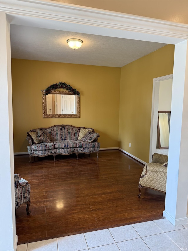 living area with baseboards and tile patterned flooring