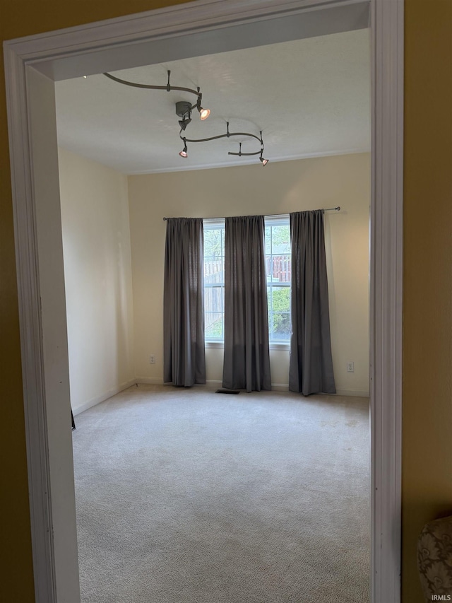 empty room with carpet floors and baseboards