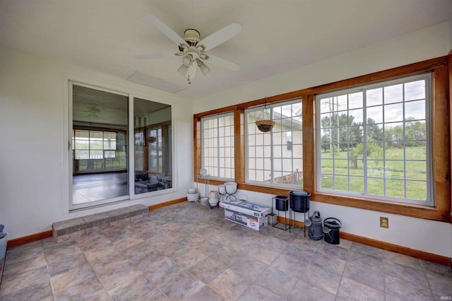 unfurnished sunroom featuring baseboards