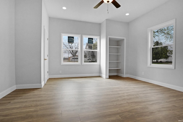 unfurnished bedroom with baseboards, wood finished floors, recessed lighting, and ceiling fan