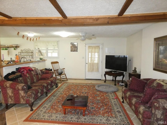 tiled living area with a textured ceiling, beam ceiling, and a ceiling fan