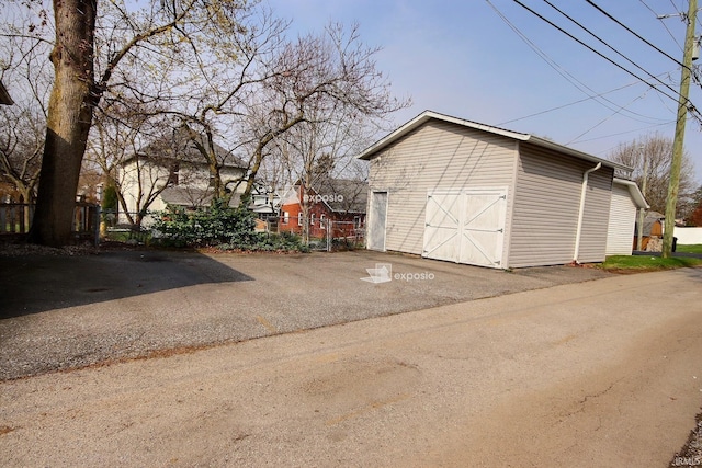 detached garage featuring fence