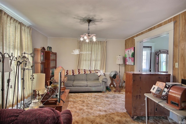 living room featuring a chandelier, carpet floors, and wood walls