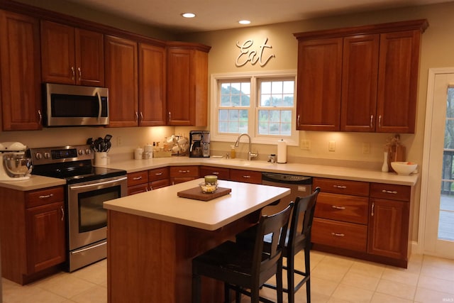 kitchen featuring light countertops, stainless steel appliances, and a sink