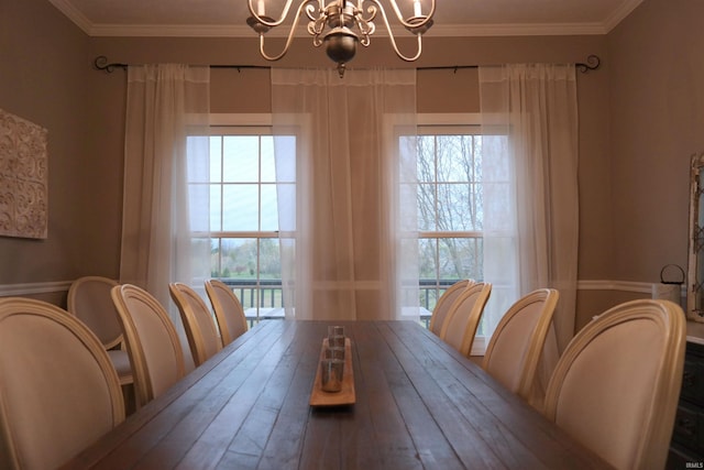 dining area with an inviting chandelier and crown molding