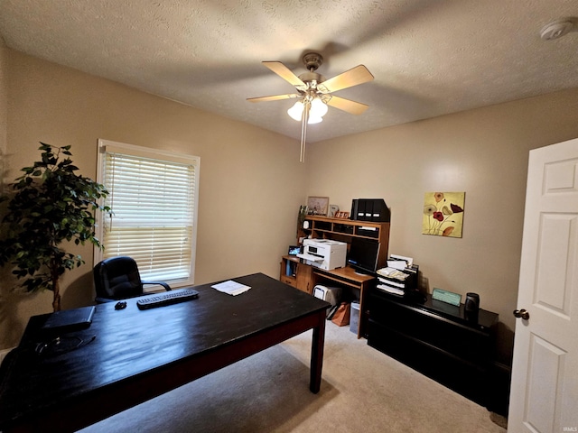 carpeted office featuring a ceiling fan