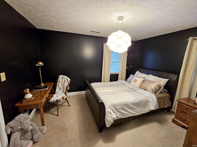 bedroom with a textured ceiling, carpet, visible vents, and baseboards