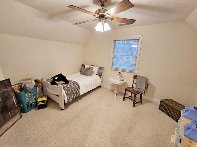 carpeted bedroom featuring lofted ceiling, visible vents, a ceiling fan, and baseboards