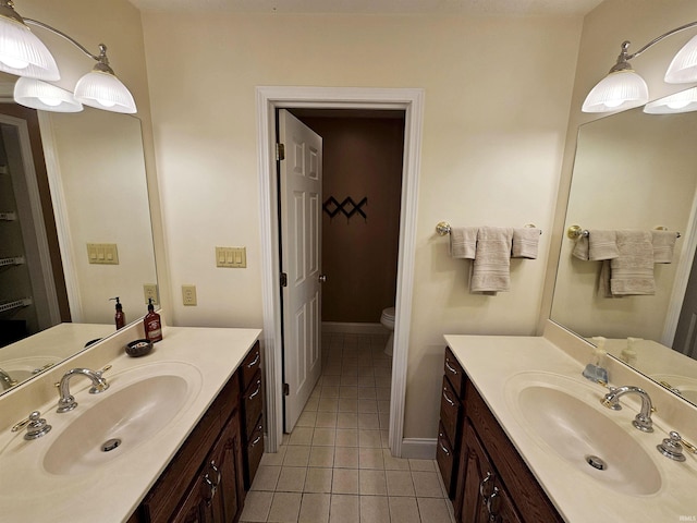 bathroom featuring two vanities, tile patterned floors, and a sink