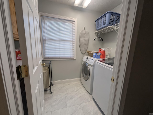 washroom with baseboards, marble finish floor, independent washer and dryer, and laundry area