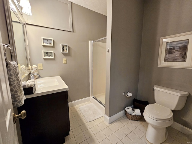 bathroom featuring baseboards, vanity, tile patterned floors, and a stall shower