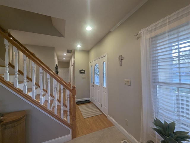 entryway with stairway, baseboards, wood finished floors, and recessed lighting