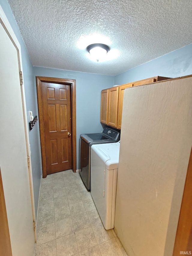 4004 Darwood Dr, Fort Wayne, IN 46815 - clothes washing area featuring cabinet space, washing machine and dryer, light tile patterned floors, and a textured ceiling