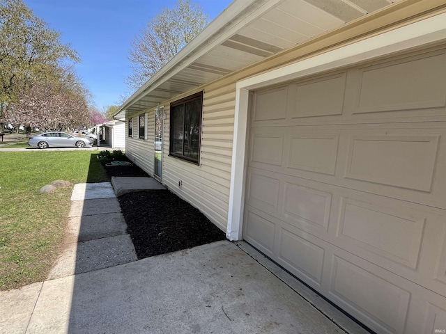 view of home's exterior featuring a yard and a garage