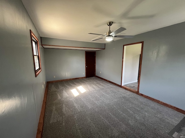 carpeted empty room with baseboards and ceiling fan