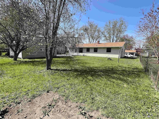 back of property with a lawn and a chimney