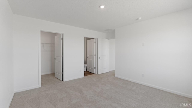 3353 Sika Trl, Waterloo, IN 46793 - unfurnished bedroom featuring carpet flooring, a walk in closet, and a closet