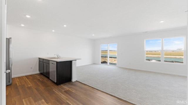 3353 Sika Trl, Waterloo, IN 46793 - kitchen with a peninsula, dark wood finished floors, stainless steel appliances, recessed lighting, and open floor plan