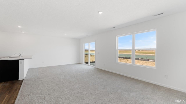 3353 Sika Trl, Waterloo, IN 46793 - unfurnished living room with recessed lighting and dark carpet