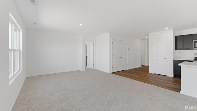 3353 Sika Trl, Waterloo, IN 46793 - unfurnished living room featuring carpet floors, recessed lighting, and healthy amount of natural light