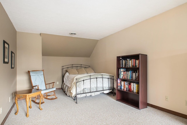 carpeted bedroom with visible vents, vaulted ceiling, and baseboards